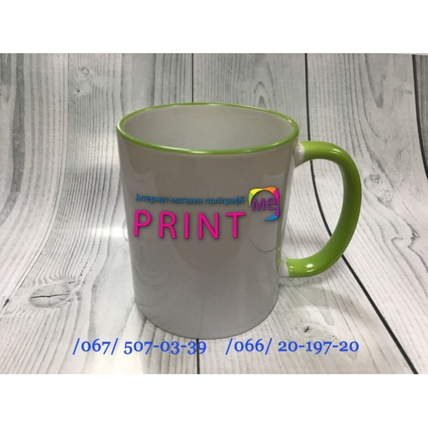 Cup with a green handle and a rim
