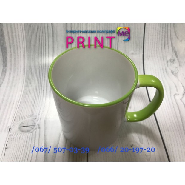 Cup with a green handle and a rim
