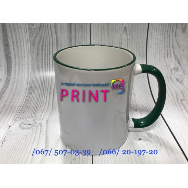 Cup with a dark green handle and a rim