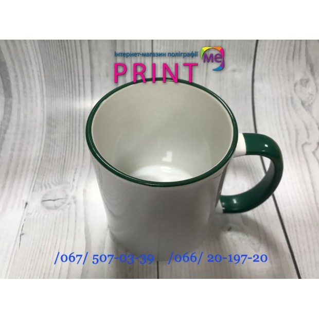 Cup with a dark green handle and a rim