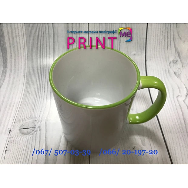 Cup with a green handle and a rim